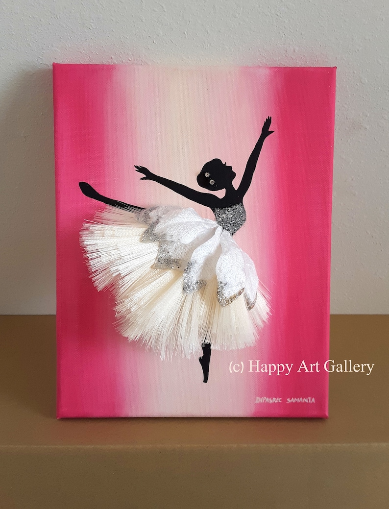 May include: A pink and white ombre canvas painting of a ballerina silhouette with a white tulle tutu. The tutu is textured and has glitter accents. The painting is signed "(c) Happy Art Gallery" and "Dipsree Samanta".