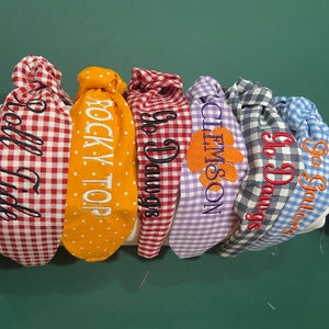 Collegiate knotted headband with machine embroidered slogan