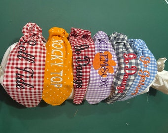 Collegiate knotted headband with machine embroidered slogan