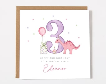 May include: A square greeting card with a brown envelope featuring a watercolor illustration of a large purple number 3, a pink dinosaur wearing a party hat, a pink balloon, a gift box, and a cupcake. Text reads: HAPPY 3RD BIRTHDAY TO A SPECIAL NIECE Eleanor.