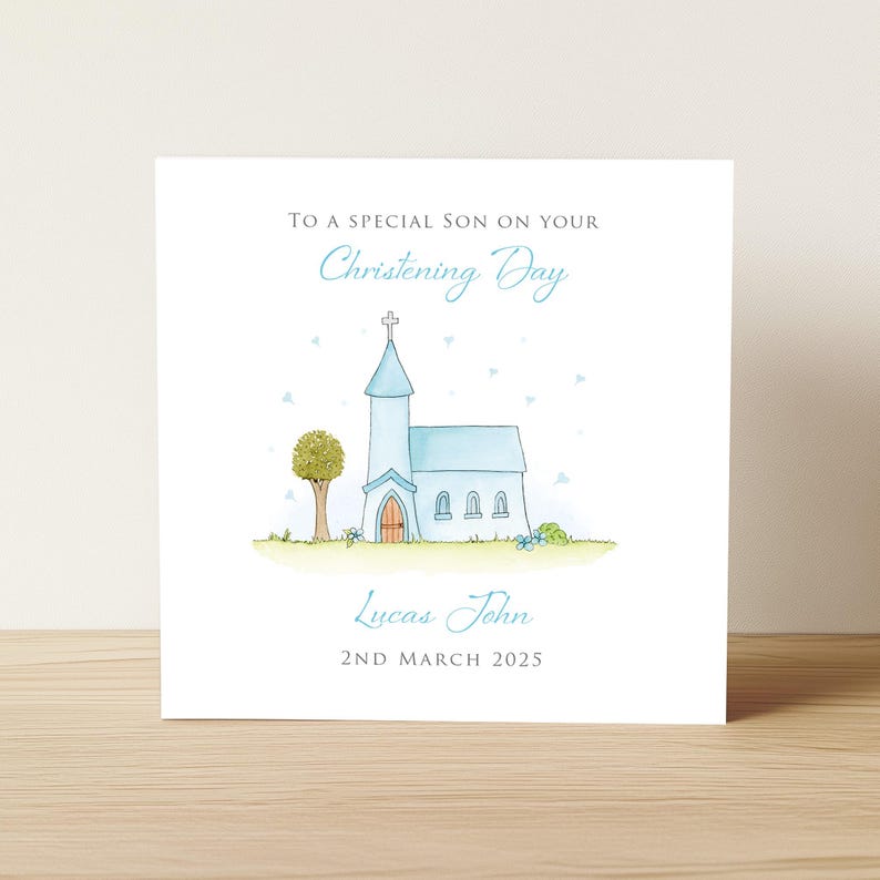 Op de afbeelding: Een vierkante wenskaart met een witte achtergrond en een aquarelillustratie van een lichtblauwe kerk met een toren en een boom. De tekst luidt: TO A SPECIAL SON ON YOUR Christening Day, Lucas John, 2ND MARCH 2025 in blauw en grijs.