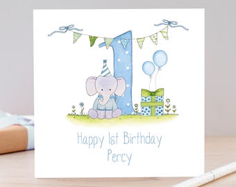 May include: A square greeting card featuring a watercolor illustration of a light purple elephant wearing a striped party hat, sitting next to a large blue number one, a gift box with two blue balloons, and bunting, with the text Happy 1st Birthday Percy.