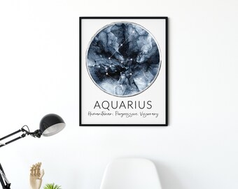 May include: A framed print featuring the Aquarius zodiac sign. The artwork has a circular design with a dark blue and silver abstract pattern and constellation lines. The word "AQUARIUS" is printed below, along with the words "Humanitarian. Progressive. Visionary."