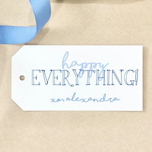 May include: A white gift tag with blue text that reads "happy EVERYTHING! xo, alexandra".