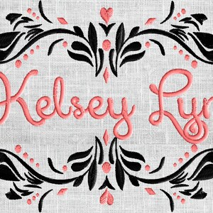 May include: Embroidered design with a black floral frame and pink lettering that reads "Kelsey Lynn".