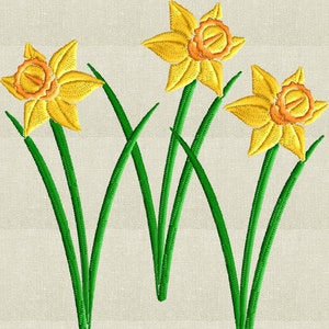 May include: Three yellow daffodils with orange centres and green stems on a beige background.