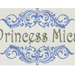 May include: Embroidered design with a blue floral border and the text "Princess Mica" in grey.