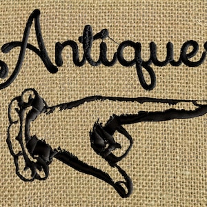 May include: A black embroidered sign with the word "Antiques" in a cursive font. A black embroidered pointing hand is below the word.