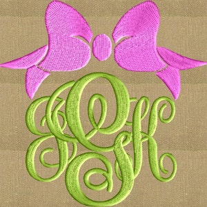 May include: A pink embroidered bow sits above a green monogram with the letters O, F, and K. The monogram is in a cursive font. The background is a tan, textured fabric.