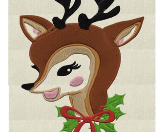 May include: Embroidered design of a brown reindeer with black antlers, wearing a red bow and a green holly wreath around its neck.