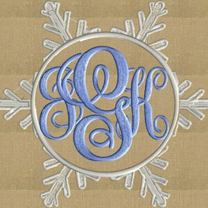 May include: A blue monogram in a circle with a white snowflake design around it.