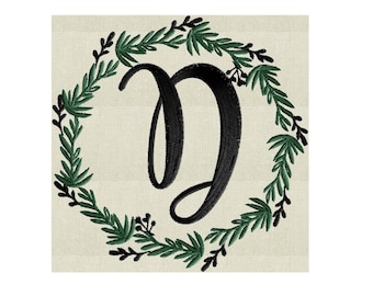 May include: A black letter D in a cursive font surrounded by a green wreath.