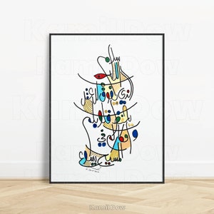May include: A colourful abstract calligraphy artwork with Arabic script in black, blue, green, red, yellow, and orange. The artwork is framed in a black frame and is on a white background.