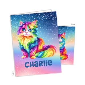 May include: A greeting card featuring a fluffy, multi-colored rainbow cat with large blue eyes against a starry night sky background. The name CHARLIE is printed in bold blue letters at the bottom. The image shows both the front and back views.