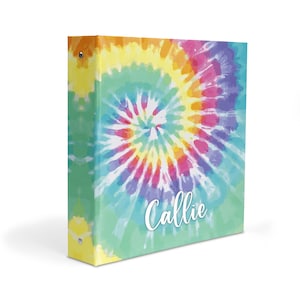 May include: A colorful tie-dye binder with the name "Callie" printed in white on the front.