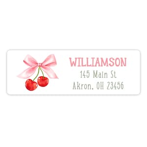 May include: A pink and white return address label with a watercolor illustration of a pink bow and two red cherries. The text "WILLIAMSON", "145 Main St", and "Akron, OH 23456" is printed in gray.