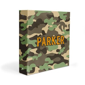May include: A green, brown, and beige camouflage binder with the name "PARKER" in orange text.
