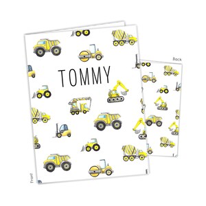 May include: A white background with a yellow construction vehicle pattern. The text "TOMMY" is in black letters. The front of the card has the text "Front" and the back of the card has the text "Back".