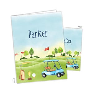 May include: A personalized golf-themed notebook with a blue golf cart, green grass, and a blue sky. The front cover features the name "Parker" and a golf bag with clubs. The back cover features a blue golf cart.