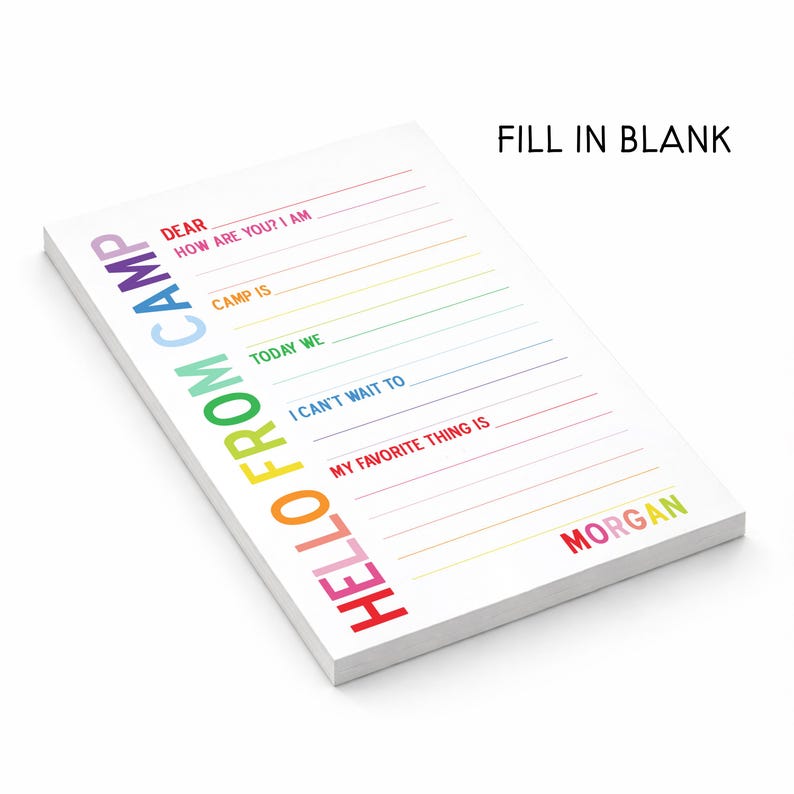 May include: A white notepad with the text HELLO FROM CAMP printed vertically in rainbow colors. The page features fill-in-the-blank lines with prompts including DEAR, HOW ARE YOU? I AM, CAMP IS, TODAY WE, I CAN'T WAIT TO, MY FAVORITE THING IS, and the name MORGAN.