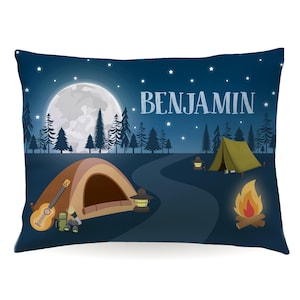 May include: A blue camping pillow with a full moon, stars, trees, a campfire, two tents, a guitar, and the name "BENJAMIN" printed on it.