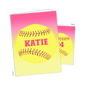 May include: A pink and yellow gradient card with a softball on the front. The softball is yellow with black stitching and a pink "KATIE" written on it. The back of the card has a softball with the number "24" on it.