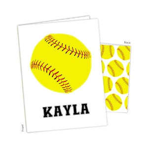 May include: A white card with a yellow softball and the name "KAYLA" printed in black. The back of the card has a repeating pattern of yellow softballs.