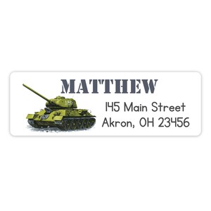 May include: A rectangular address label with the name "MATTHEW" in dark gray text. A detailed illustration of a green tank is on the left. The address "145 Main Street, Akron, OH 23456" is printed in black.