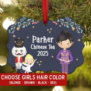 May include: Navy blue Christmas ornament with a red ribbon. The ornament features a cartoon illustration with the text "Parker Chinese Tea 2025". The ornament also has the text "CHOOSE GIRLS HAIR COLOR (BLONDE • BROWN • BLACK • RED)".