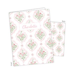 May include: A rectangular card featuring a repeating pattern of pink roses and green leaves inside light pink decorative frames on a white background. The front displays the name Charlotte in pink script within a white rectangular label.