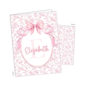 May include: A rectangular card featuring a pink and white floral toile pattern. The front displays a large pink bow above an oval frame containing the name Elizabeth in pink script over a large letter E. The back shows the same floral pattern.