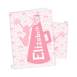 May include: A rectangular greeting card featuring a light pink background with a repeating pattern of bows and floral motifs. A large pink megaphone graphic is centered with the name Elizabeth in white text, alongside a cheerleader silhouette.