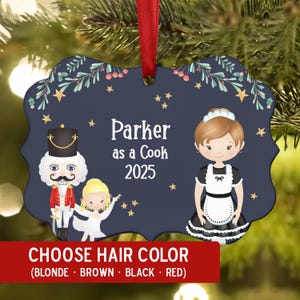 May include: Navy blue Christmas ornament with a red ribbon. The ornament features a cook and a nutcracker illustration, with the text "Parker as a Cook 2025". A red banner at the bottom reads "CHOOSE HAIR COLOR".