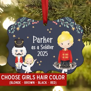 May include: Navy blue ornament with a red ribbon, featuring a cartoon soldier and ballerina design. The text reads "Parker as a Soldier 2025". The bottom banner says "CHOOSE GIRLS HAIR COLOR (BLONDE • BROWN • BLACK • RED)".