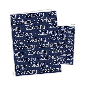 May include: A navy blue card with the name "Zachary" repeated in white text on the front and back.