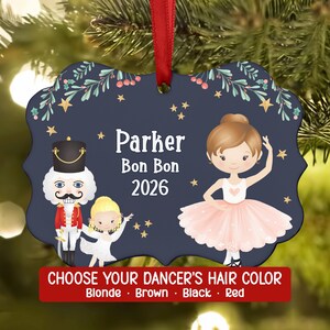 May include: A dark blue, scalloped-edge Christmas ornament hanging from a red ribbon. It features a nutcracker, a small dancer, and a ballerina with the text "Parker Bon Bon 2026" and "CHOOSE YOUR DANCER'S HAIR COLOR Blonde Brown Black Red".