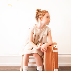 Beautiful linen dress in natural color and piping detail. Hand made from high quality European linen.