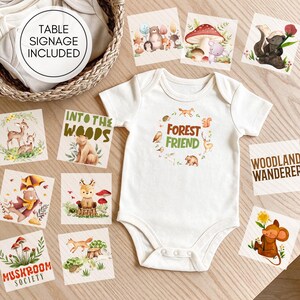 May include: A white short-sleeved baby bodysuit featuring a central graphic with the text FOREST FRIEND surrounded by small woodland animals. The bodysuit is surrounded by several square cards displaying various forest-themed illustrations and text.