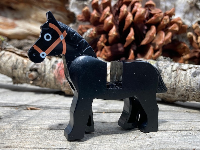LEGO® horse with black eyes circled with white and a detailed brown bridle pattern, perfect for your LEGO® farm or medieval scenes.