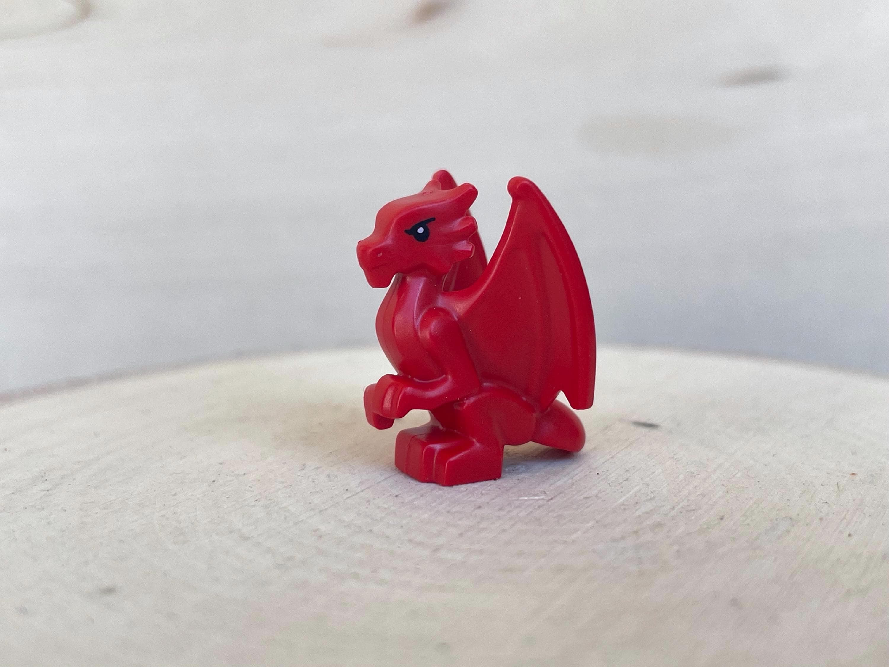 Red Baby Dragon, Perched With Folded Wings, Black Eyes and