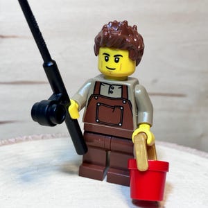 Fisherman in Brown Overalls Holding a Fishing Pole and Bait Bucket – Genuine LEGO® Minifigure