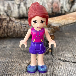 Mia wearing Dark Purple Shorts and a Magenta Top with Orange and Dark Purple Stripes - Friends, Genuine LEGO® Minifigure