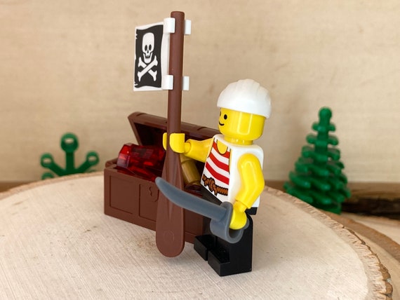 Pirate Holding a Jolly Roger Flag and Cutlass With a Full Treasure