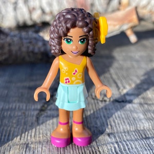 Andrea wearing a Light Aqua Layered Skirt and Bright Light Orange Top with Music Notes, Bow - Friends, Genuine LEGO® Minifigure