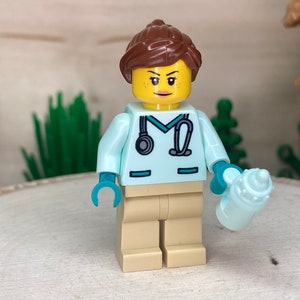 Female Veterinarian in Light Aqua Scrubs Holding Baby Bottle - City, Genuine LEGO® Minifigure