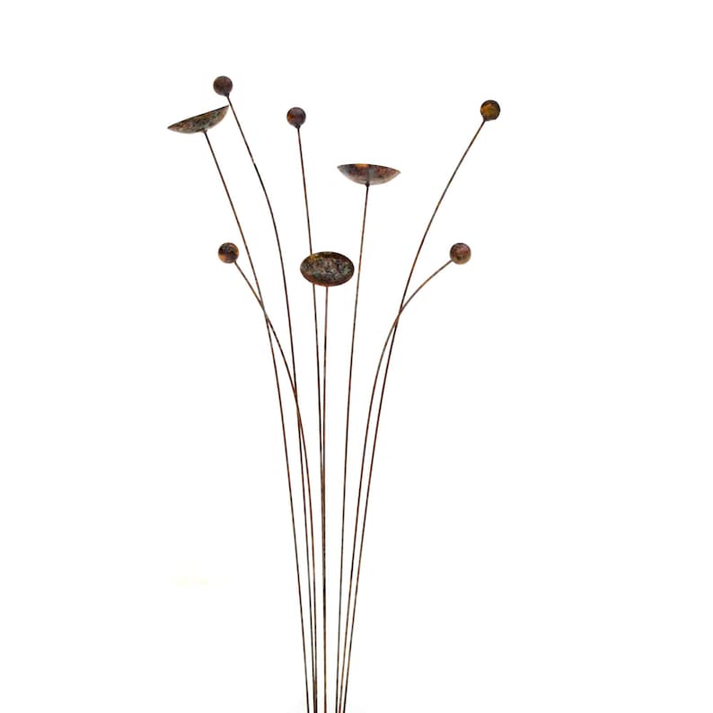 Metal kinetic garden art with rust patina