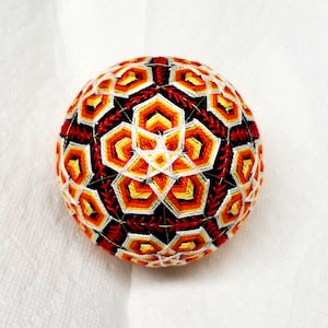 4 Inch Diameter Japanese Temari Ball (Embroidered Ornamental Ball), Overlapping White-Yellow-Orange Flower Petals on Black Ball w/ Red Trim