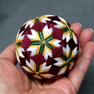 2.5 Inch Diameter Japanese Temari Ball (Embroidered Ornamental Ball), White Flower Pattern with Burgundy on Green Ball