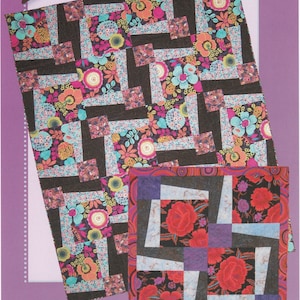 May include: A quilt pattern with the title "BQ3" and the text "Maple Island Quilts". The pattern features a colorful floral design with black, white, and blue accents.