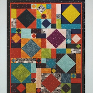 May include: A colorful quilt pattern called "Fourteen on Point" with a geometric design featuring squares and diamonds in various colors, including red, orange, yellow, green, blue, and black. The quilt is framed with a black border.